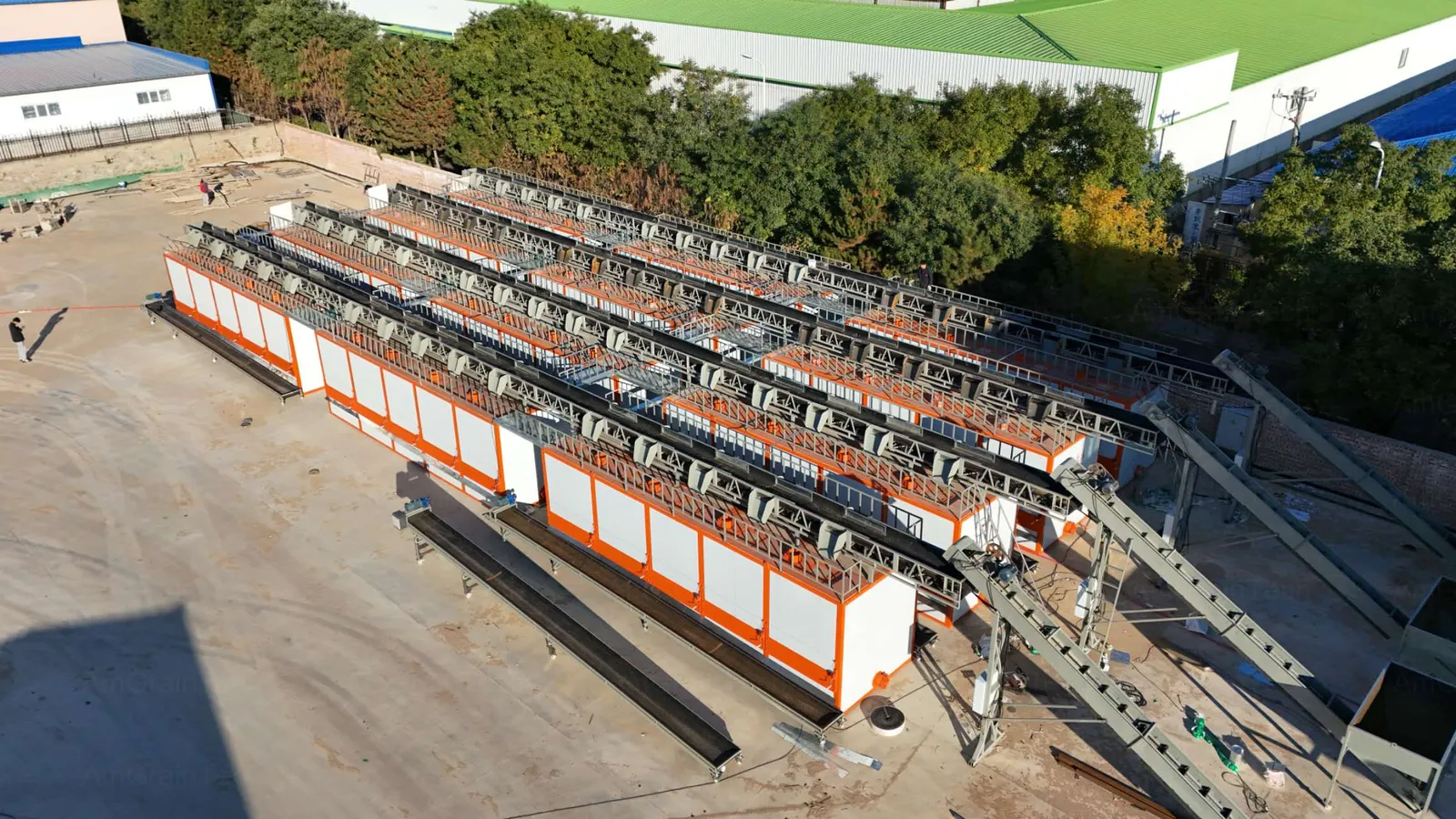 AmGrainTech low-temperature batch grain dryer installed at the Eastern Europe 120 TPD drying project, drying tower base with the project team for scale reference